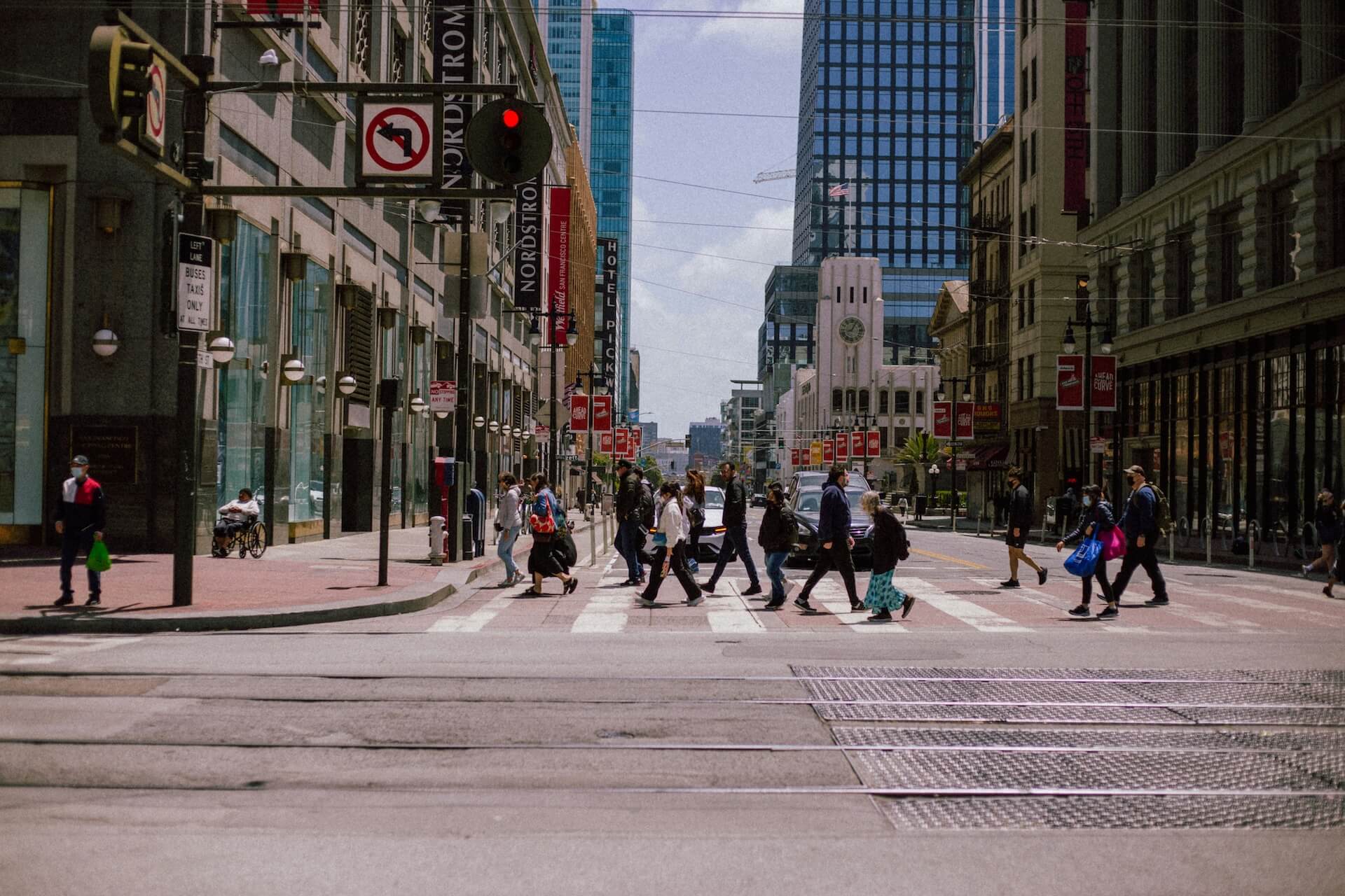 Pedestrians crossing a street in downtown San Francisco near the Ferry Building