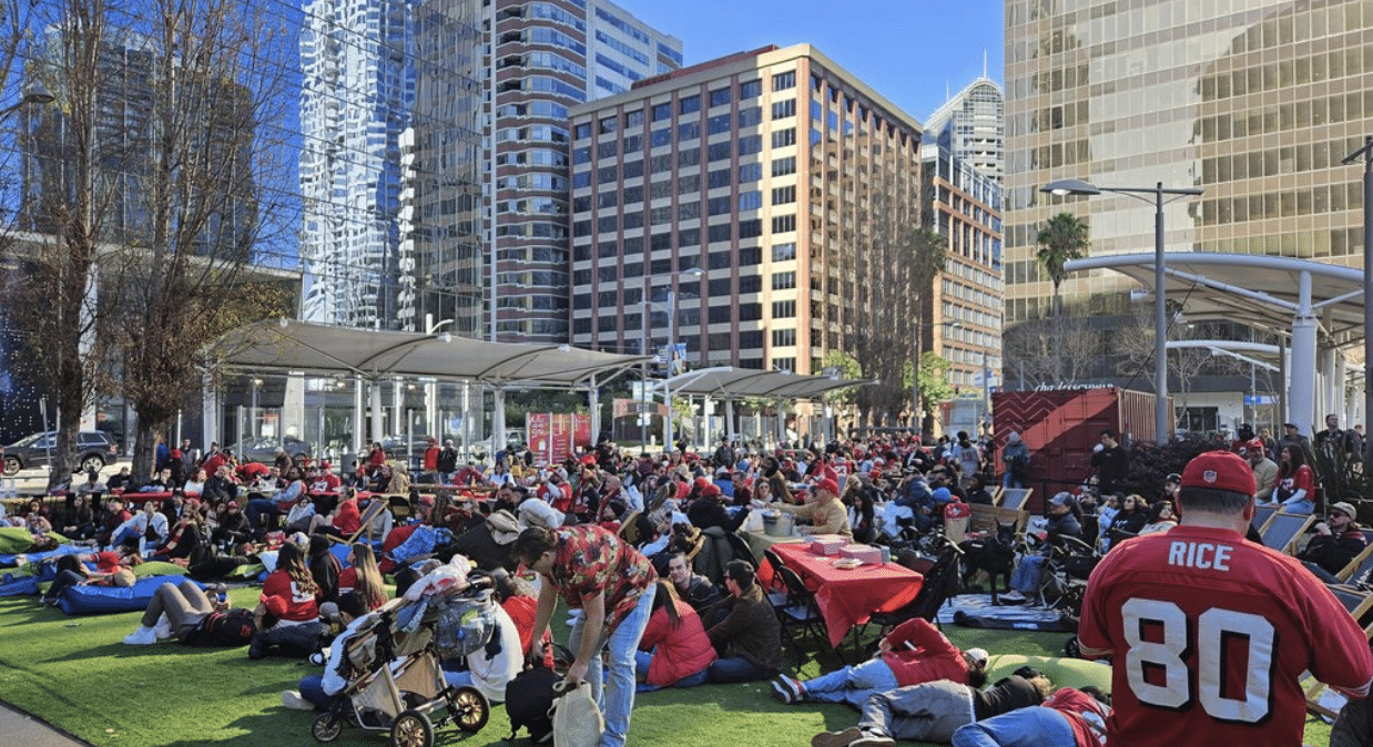 Crowd gathered in a downtown San Francisco park for a Super Bowl watch party