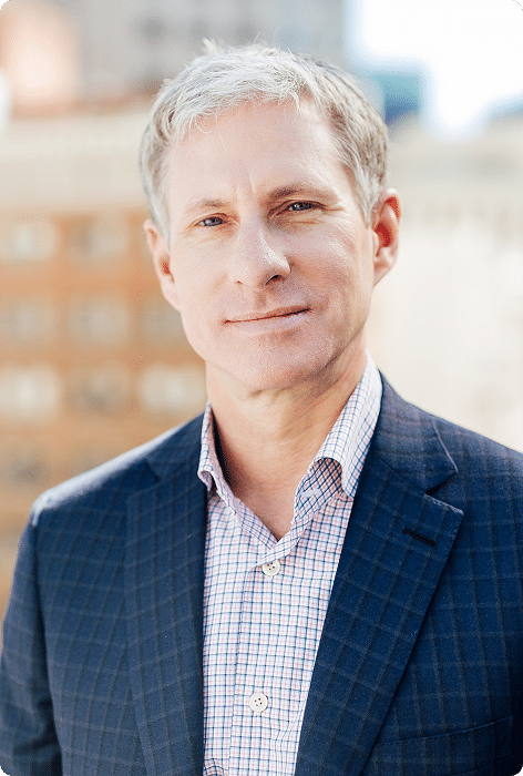 Chris Larsen, smiling in a professional headshot