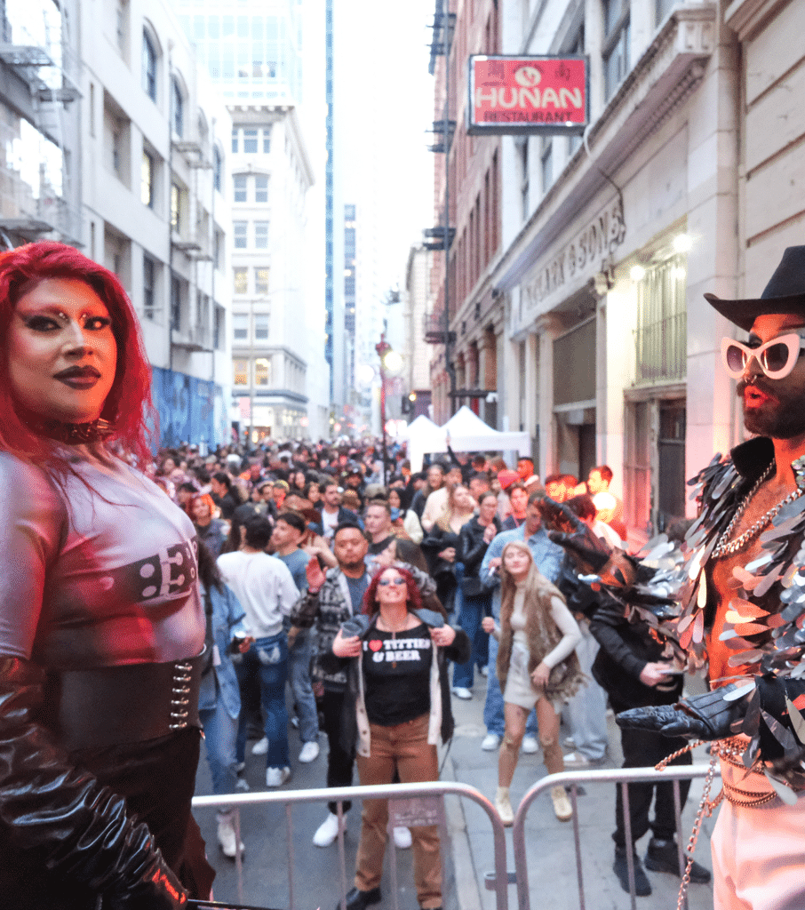 Performers in costume engaging a crowd during a lively street event in downtown San Francisco