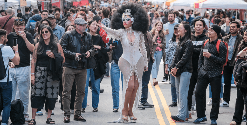 Performer in a white costume entertaining a crowd at a busy outdoor street festival