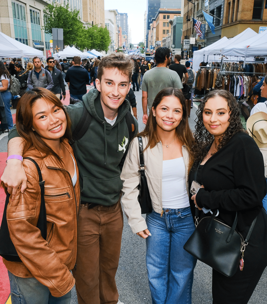 Group of people posing together at an outdoor street market in downtown San Francisco