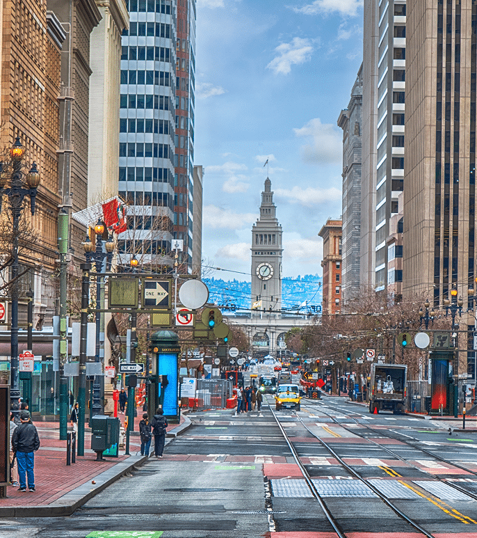Market Street in downtown San Francisco with the Ferry Building clock tower in the background