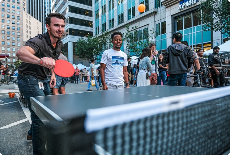 People playing ping pong at an outdoor street party in downtown San Francisco