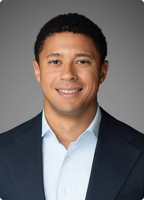 TJ Wenzel, smiling in a professional headshot
