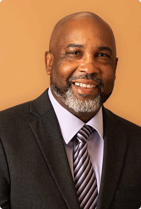 Sam Cobbs, smiling in a professional headshot
