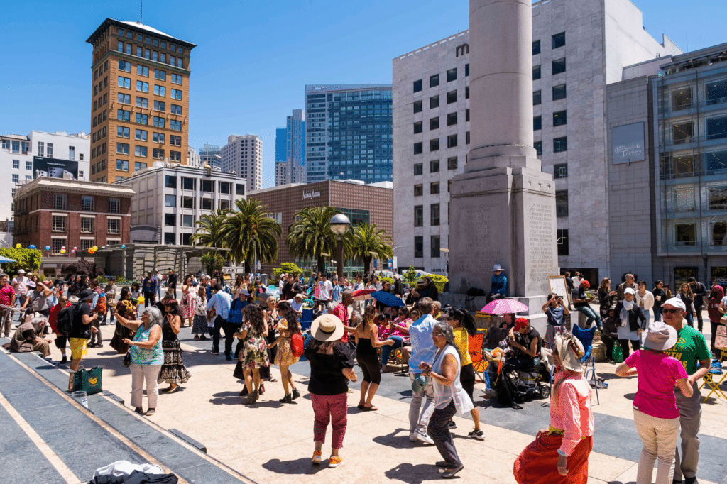 Crowd of people dancing in Union Square in downtown San Francisco